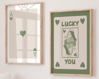 May include: Two printable wall art prints with a green background and white text. The first print features a playing card with the Ace of Hearts. The second print features a playing card with the Queen of Hearts and the text "Lucky You".