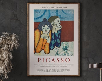 May include: A vintage poster advertising a Picasso exhibition at the Maison de la Pensée Française in Paris, France. The poster features a painting of two figures, one in a yellow shirt and the other in a blue and white checkered shirt, with the text "PICASSO" in large letters.