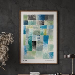 May include: A framed abstract art print featuring a geometric design of squares in shades of blue, green, and grey. The print is titled "One Who Understands" by P. Klee.