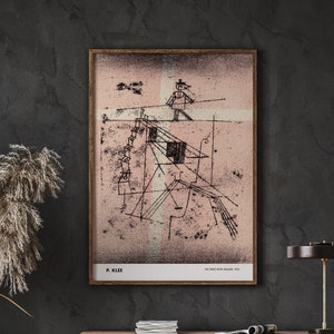 May include: A black and white abstract art print with a pink background. The print features geometric shapes and lines. The artist's name, "P. Klee", and the title of the artwork, "The Tight Rope Walker", are printed at the bottom of the print.