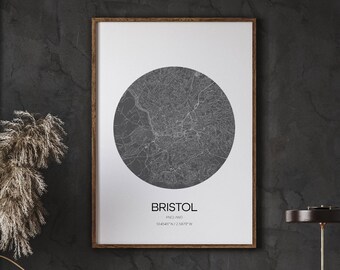 May include: A framed print of a black and white map of Bristol, England. The map is in a circle and the city name is printed below the map.