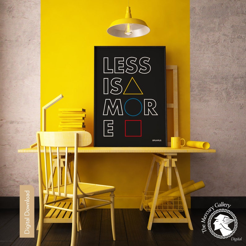 May include: A black and white printable wall art print with the text "Less is More" in a geometric design with a yellow triangle, blue circle, and red square. The print is displayed on a yellow wall in a home office setting.