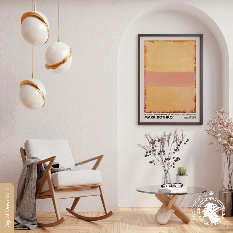 May include: A digital download of a minimalist abstract painting by Mark Rothko. The painting features a single horizontal band of pink against a yellow background. The painting is framed in a black frame and is hanging on a white wall.