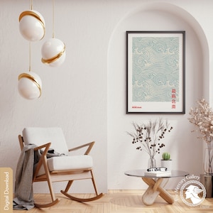 May include: A framed print of a blue and white wave pattern with Japanese text. The print is hanging on a white wall in a room with a rocking chair and a coffee table.