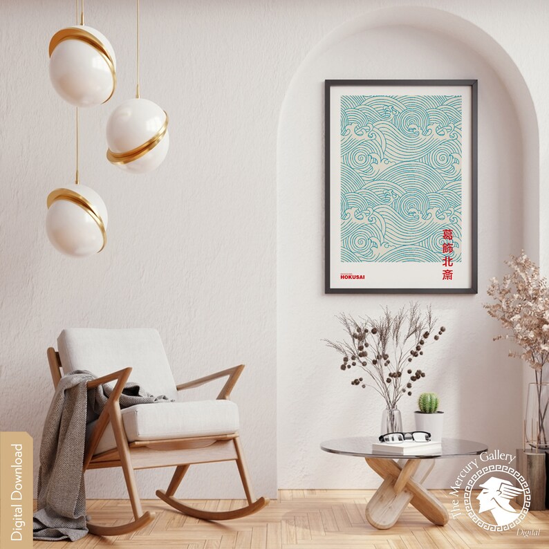 May include: A framed print of a blue and white wave pattern with Japanese text. The print is hanging on a white wall in a room with a rocking chair and a coffee table.