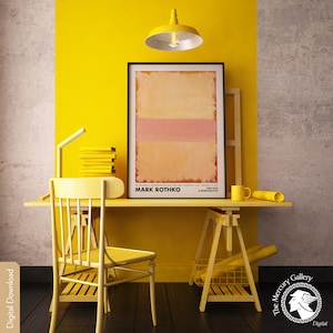 May include: A yellow desk with a yellow chair, a yellow easel, and a framed abstract painting by Mark Rothko. The painting is a light orange with a pink horizontal stripe. The text "Mark Rothko" is printed below the painting.