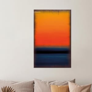 May include: Abstract art print featuring a gradient of colors. The artwork transitions from orange at the top, through red, to a dark blue at the bottom. A black horizontal line separates the red and blue sections. The canvas has a dark brown border.