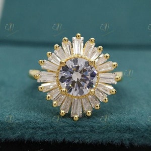 May include: A gold ring with a large round clear stone surrounded by smaller baguette-shaped clear stones. The ring is set in a flower-shaped design.