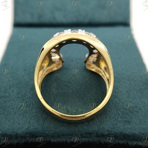 May include: A gold ring with a unique open design and a row of clear stones set in the band.