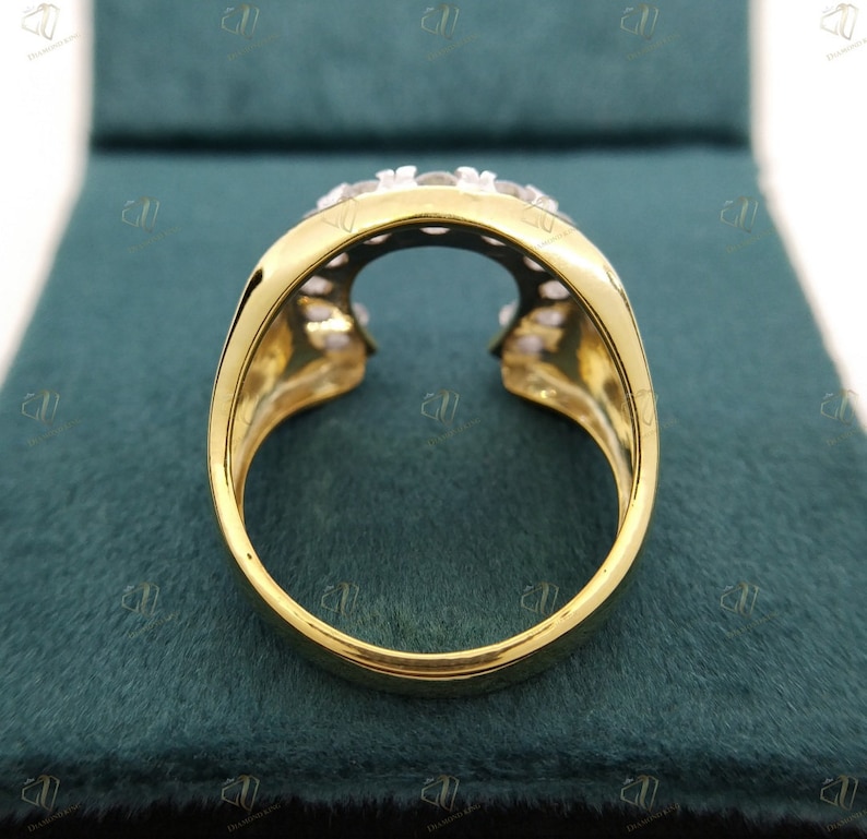 May include: A gold ring with a unique open design and a row of clear stones set in the band.