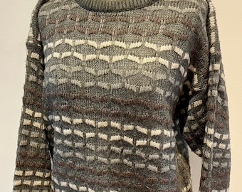 May include: A grey, brown and white striped jumper with a crew neck.