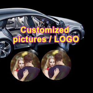 May include: A silver car with open doors projecting circular light displays onto the ground. The projections show a photograph of a person embracing another person. The text Customized pictures / LOGO is overlaid in yellow on the car image.