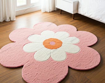 Peut inclure: Un tapis en forme de fleur rose et blanche avec un grand centre orange. Le tapis est fait d'un matériau doux et moelleux et a une forme ronde.