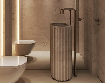 May include: A modern bathroom design featuring a neutral color palette. The space includes a wall-mounted toilet, a ribbed pedestal sink, and a minimalist faucet. The walls have arched, backlit accents, and the overall aesthetic is clean and contemporary.