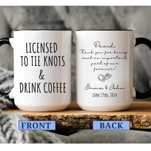 May include: White ceramic mug with black handle and rim. The front reads "LICENSED TO TIE KNOTS & DRINK COFFEE". The back has a personalized message, names, and a date. A wedding-themed gift.