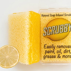 May include: A yellow sponge scrubber with the text "Natural Soap Infused Scrubber" and "SCRUBBY" on the packaging. The packaging also says "Easily removes paint, oil, dirt, grease & more!"