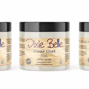 May include: Three 16-ounce jars of Dixie Belle Clear Coat in Gloss, Flat, and Satin finishes. The jars are white with black lids and feature a brown and white label with the Dixie Belle logo and product details.