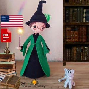 May include: A handmade crochet doll dressed as a wizard, wearing a black hat with a green feather, a green robe, and round glasses. The doll is holding a glowing wand. A small crochet cat is also present.