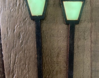 May include: Two wooden miniature streetlights with black posts and green glass lampshades.