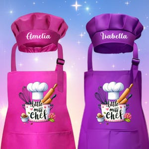 May include: Two personalized aprons and chef hats. One apron is magenta, the other is purple. Each apron has a "Little Miss Chef" graphic and a name on the hat. The magenta hat says "Amelia", and the purple hat says "Isabella".