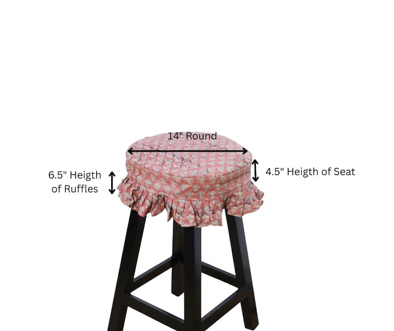 May include: A round stool cover with a pink and white floral pattern, featuring a 6.5-inch ruffle trim and a 4.5-inch seat height. The cover is 14 inches round and sits atop a black wooden stool with four legs and a square base support structure.
