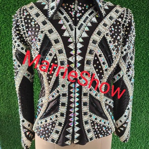 May include: Black and white show shirt with rhinestones and a zipper closure. The shirt has a geometric pattern and the text "Marlie Show" is visible on the front.
