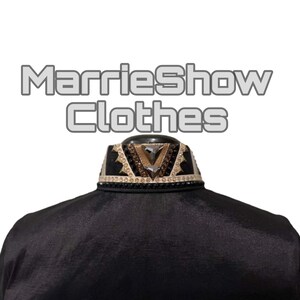 May include: Black garment with an embellished collar. The collar features a geometric design with gold, brown, and clear gemstones. The text "MarrieShow Clothes" is displayed above the garment.