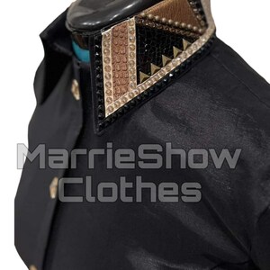 May include: Black shirt with a decorative collar. The collar features a geometric design with gold, brown, and black accents, including rhinestones and studs. The text "MarrieShow Clothes" is visible.