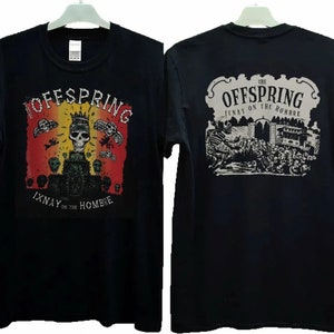 May include: Black t-shirt with a graphic print of a skull with a crown on the front. The back of the shirt has a graphic print of a band playing in front of a crowd of skeletons. The text on the shirt reads "The Offspring Ixnay on the Hombre".