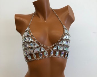 May include: A silver chain body jewelry piece with iridescent triangular and rectangular rhinestones.