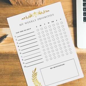 May include: A printable weekly planner featuring a gold floral design. The planner includes a section for listing your top ten to-dos and a grid for scheduling tasks by day. It also has a space to write down your motivation.