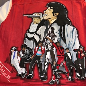 May include: A red denim jacket with a hand-painted image of Michael Jackson and the Jackson 5. The image is in a cartoon style and features the group performing on stage. The jacket is signed "Fade85 22".