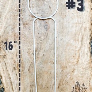 May include: White metal plant stand with a 16-inch tall support and a circular top. The stand is labeled #3.
