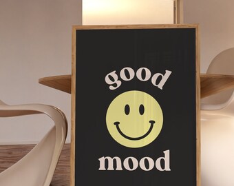 May include: A black framed poster with the text "good mood" in white and a yellow smiley face.