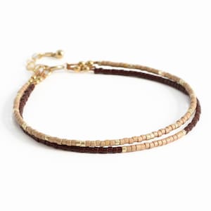 May include: A rustic wooden sign with the text "Welcome to our home" in white lettering. The sign features a distressed finish and a simple, inviting design, perfect for front door decor.