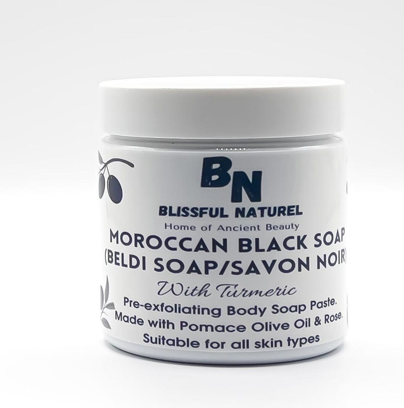 May include: A white jar of Moroccan Black Soap with the text "BN BLISSFUL NATUREL Home of Ancient Beauty". The jar also says "MOROCCAN BLACK SOAP (BELDI SOAP/SAVON NOIR) With Turmeric". The product is a pre-exfoliating body soap paste.