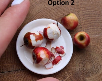 May include: A white plate with three red apples, two of which are partially peeled, and a fourth whole red apple on a wooden surface. The text "Option 2" is visible in the image.