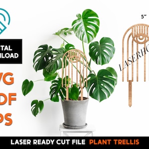 May include: A laser-cut plant trellis made of wood with a geometric design featuring an eye motif. The trellis is 5 inches wide and 11 inches tall. The design is called "Plant Trellis".