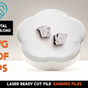 May include: A pair of laser cut wooden earrings featuring a scroll with a quill pen. The earrings are displayed on a white cloud-shaped surface. SVG, PDF, and EPS digital download files are available.