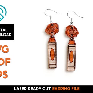 May include: A pair of laser cut wooden earrings featuring a crayon design. The earrings are orange and white with a silver hook.
