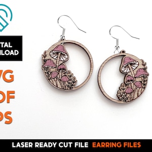 May include: A pair of laser cut wooden earrings featuring a circle design with pink mushrooms and greenery. The earrings are ready to be assembled and are perfect for a nature-themed look.