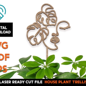 Peut inclure: Treillis en bois découpé au laser pour plantes d'intérieur, avec un design minimaliste en ligne d'un visage avec une feuille de monstera. Le treillis est conçu pour être utilisé comme support pour les plantes d'intérieur.