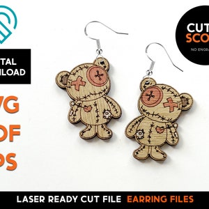 May include: Wooden bear-shaped earrings with stitched details, a button eye, and a cross-shaped mouth. The earrings are laser-cut and feature a light brown color with red accents. The image also includes text that says "DIGITAL DOWNLOAD" and "CUT & SCORE".