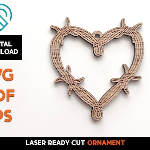 May include: A laser cut wooden heart ornament shaped like barbed wire. The ornament is ready to be used for a craft project.