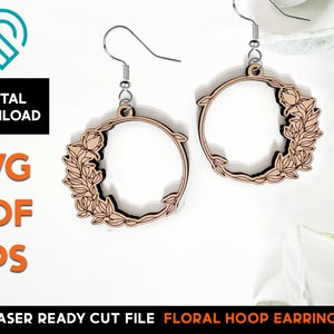 May include: A pair of laser cut wooden hoop earrings with a floral design. The earrings are light brown and have a delicate floral pattern around the hoop.