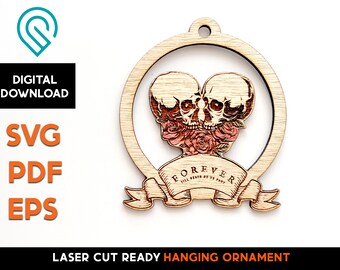 May include: Laser-cut wooden hanging ornament featuring two skulls with roses, encircled by a wooden frame. The word "FOREVER" is displayed on a banner below the skulls. The ornament is ready for laser cutting and is a digital download.