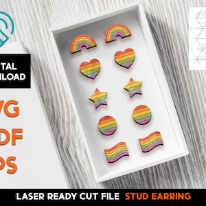 May include: A set of laser cut stud earrings featuring rainbow designs. The designs include hearts, stars, rainbows, and circles. The earrings are ready to be assembled and are perfect for a DIY project.