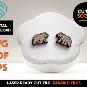 May include: A pair of laser cut wooden bear earrings. The earrings are brown and have a natural wood grain finish. The earrings are on a white background.  "CUT & SCORE NO ENGRAVING" is printed in black text on a white background.