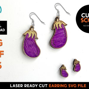 May include: Laser cut wooden earrings shaped like purple eggplants with gold stems. The earrings are ready to be assembled with earring hooks.