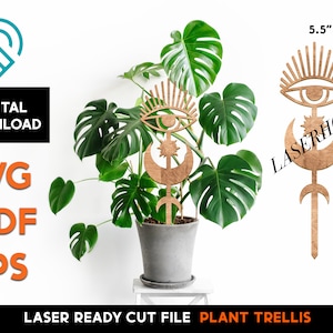 May include: A laser cut wooden plant trellis featuring a crescent moon, a star, and an eye with eyelashes. The trellis is 17 inches tall and 5.5 inches wide.  The trellis is shown in front of a potted plant.